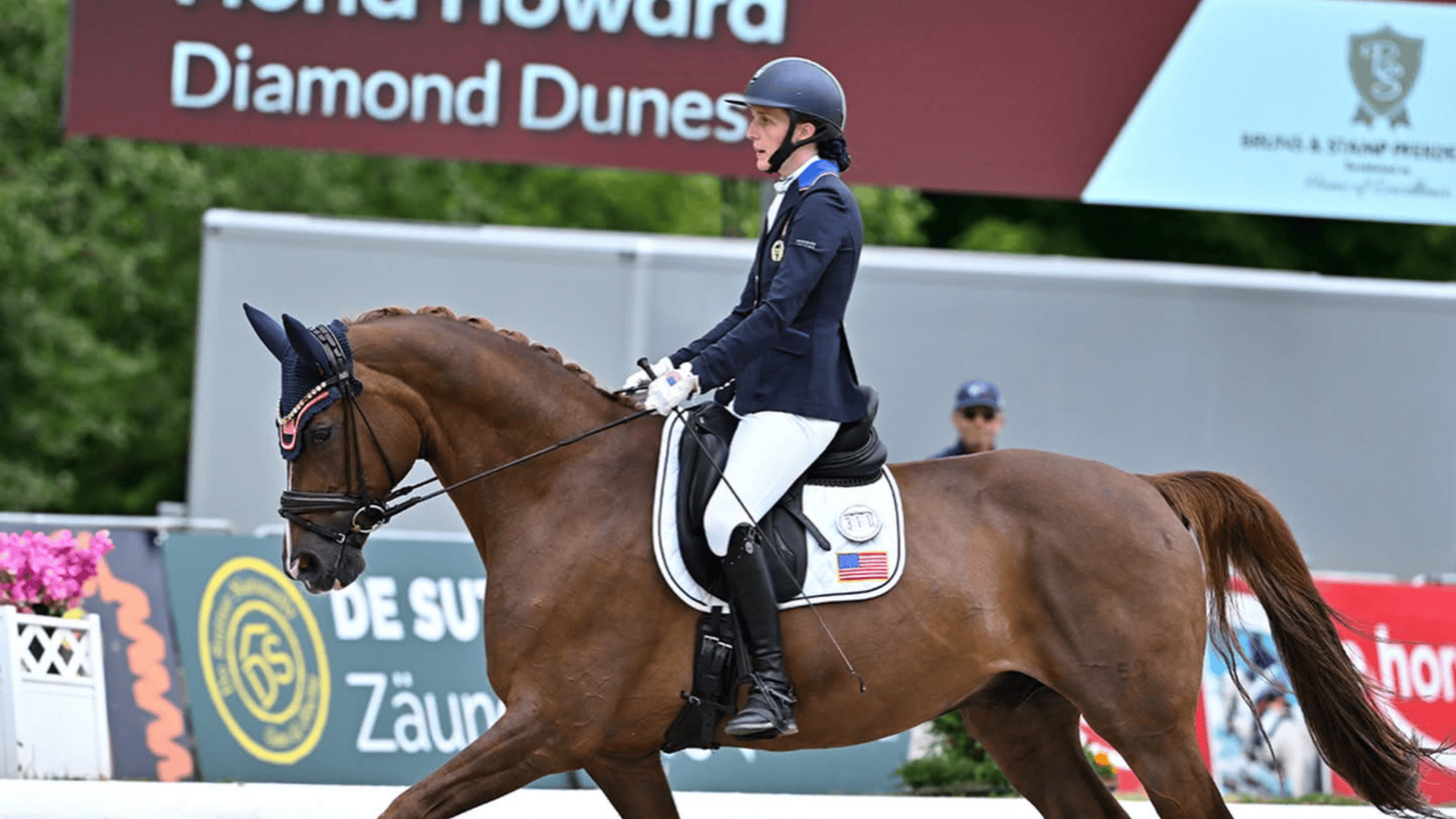 Fiona Howard riding Diamond Dunes past a sign reading Fiona Howard Diamond Dunes at the 2026 FEI Para Dressage World Championships in Aachen